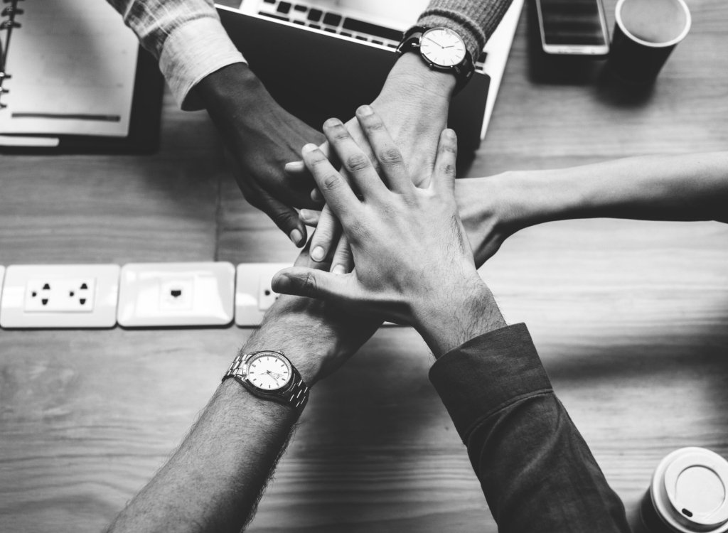 Team of business people stacking hands